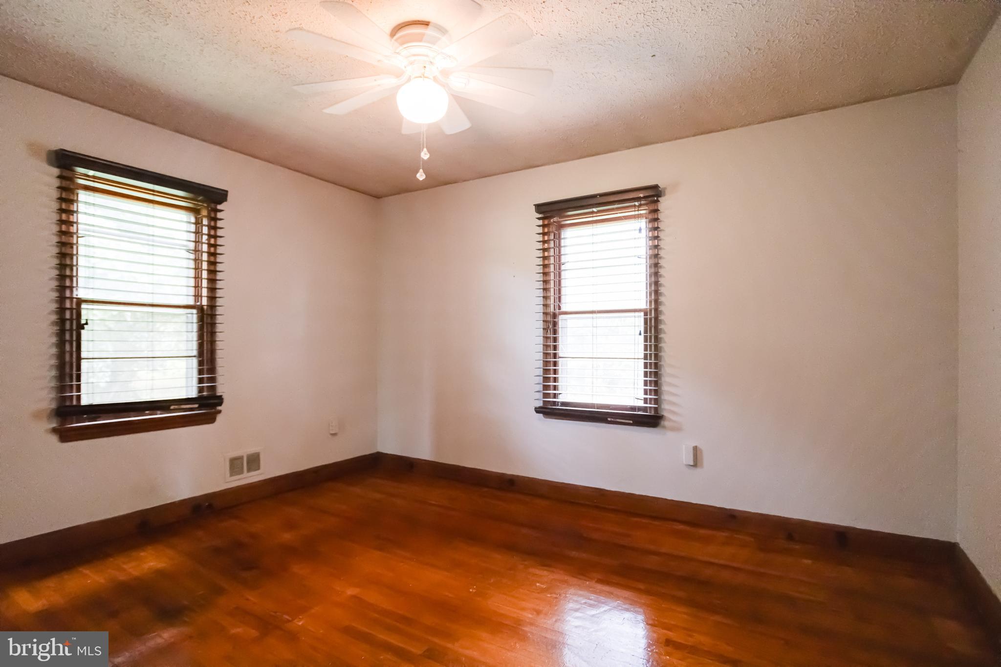 1405 Pomeroy Avenue Abingdon, MD 21009 - Photo 26 of 60 a view of an empty room with wooden floor and a window
