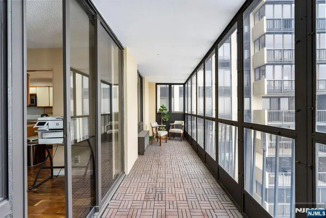 a bedroom with a bed and a view of kitchen