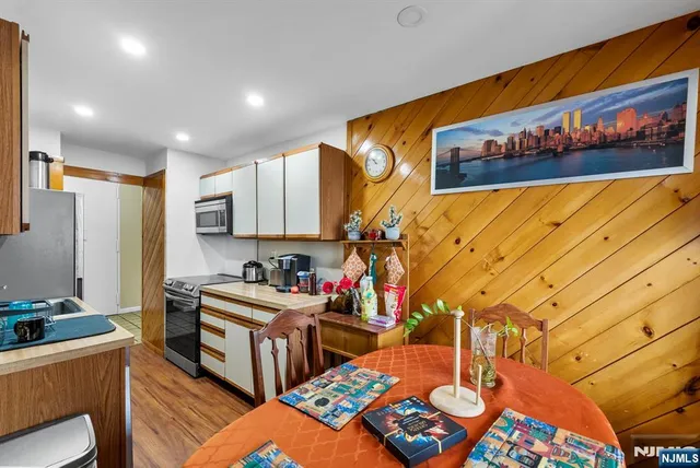 a view of a hallway with workspace and wooden floor