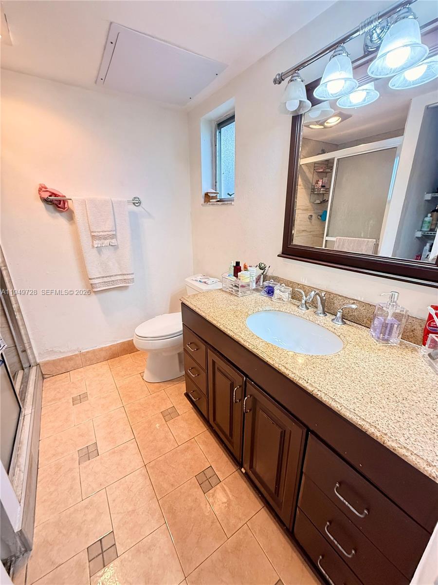 5790 Stirling Road, Unit 104 Hollywood, FL 33021 - Photo 11 of 19 a spacious bathroom with a granite countertop double vanity sink a mirror and a