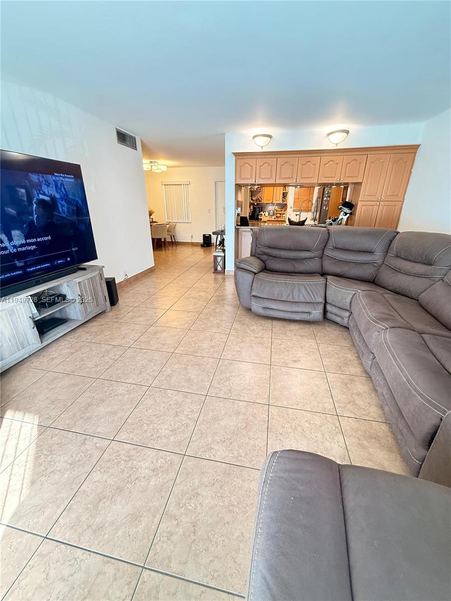 5790 Stirling Road, Unit 104 Hollywood, FL 33021 - Photo 10 of 19 a living room with a couch and a coffee table
