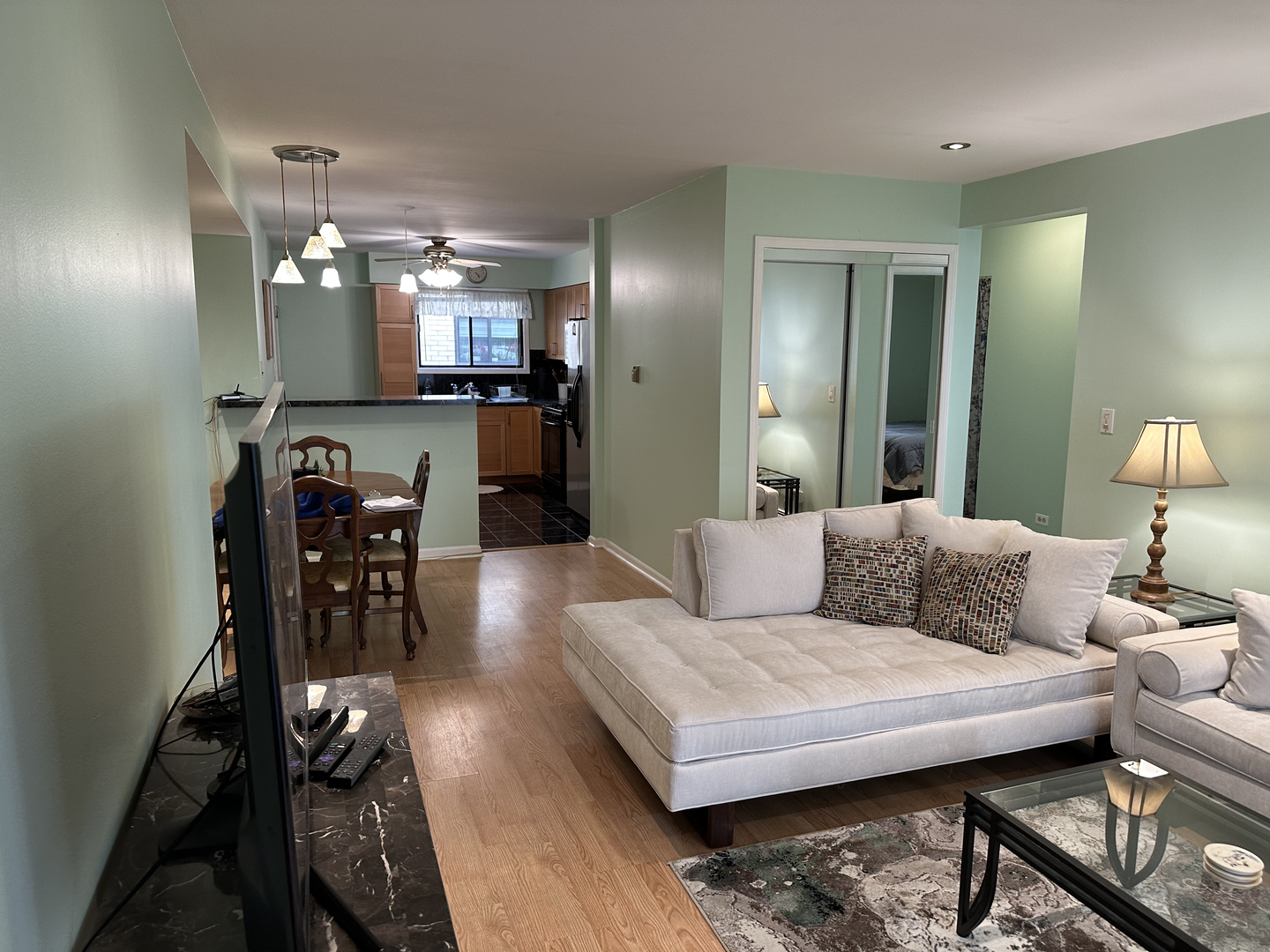 5155 North East River Road, Unit 116E Chicago, IL 60656 - Photo 2 of 10 a living room with furniture and a dining table