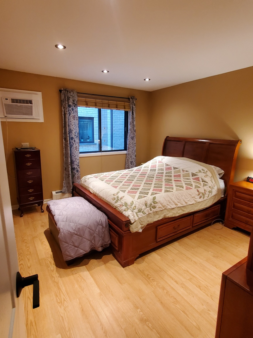 5155 North East River Road, Unit 116E Chicago, IL 60656 - Photo 10 of 10 a bedroom with a bed and dresser