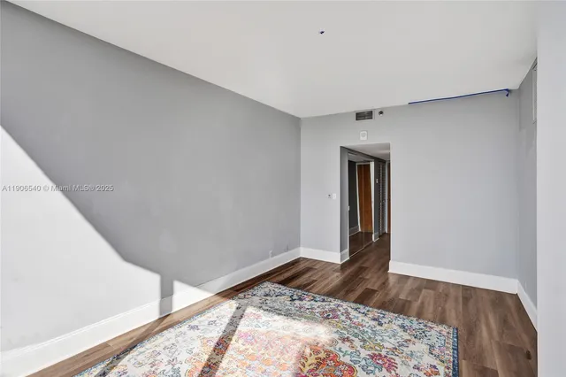 a bedroom with a bed and a rug