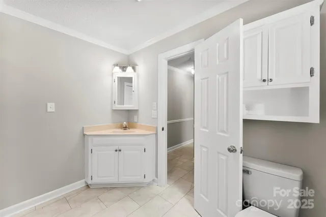 a spacious bathroom with a granite countertop sink a toilet and a mirror