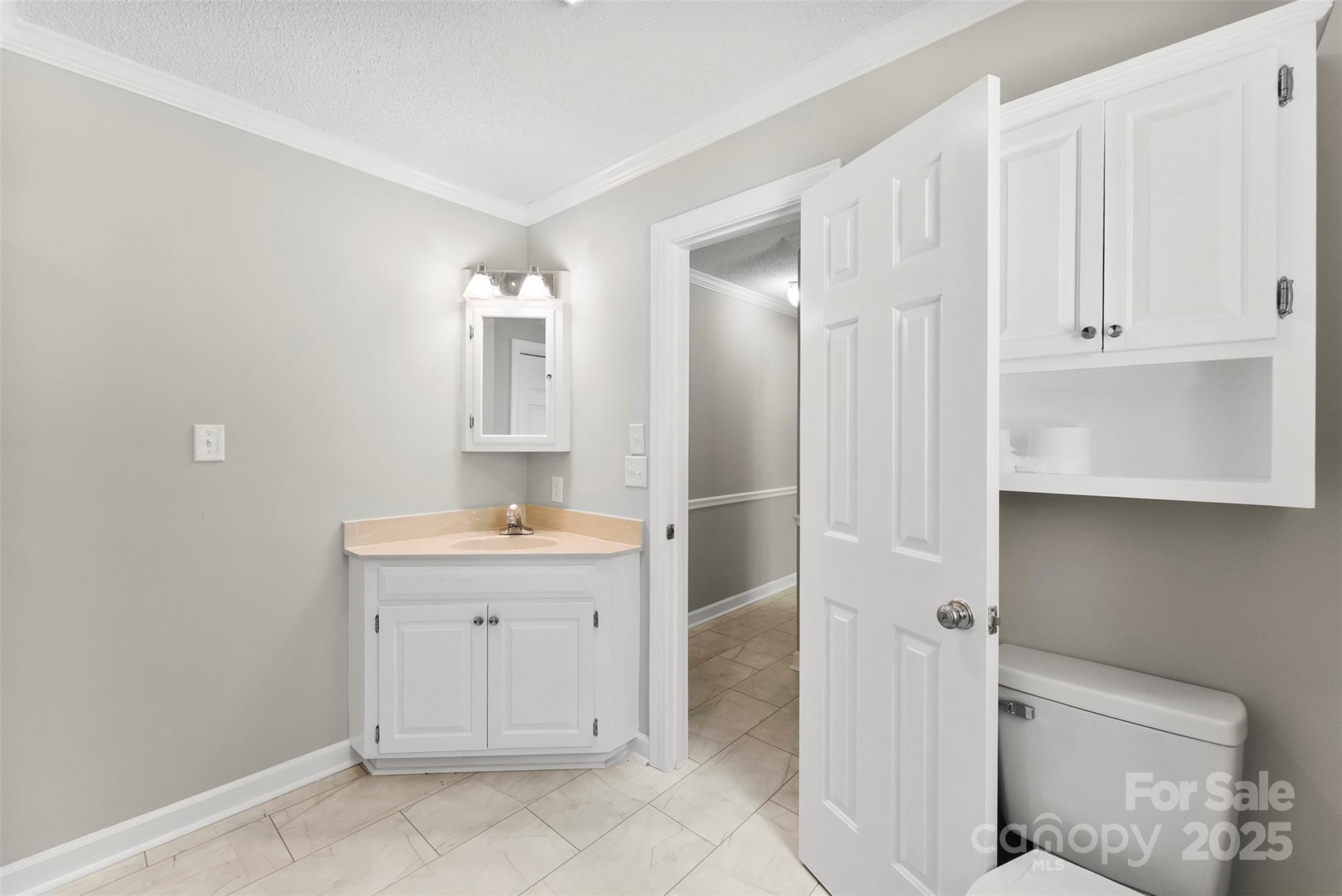 1505 North Cansler Street Kings Mountain, NC 28086 - Photo 14 of 46 a spacious bathroom with a granite countertop sink a toilet and a mirror