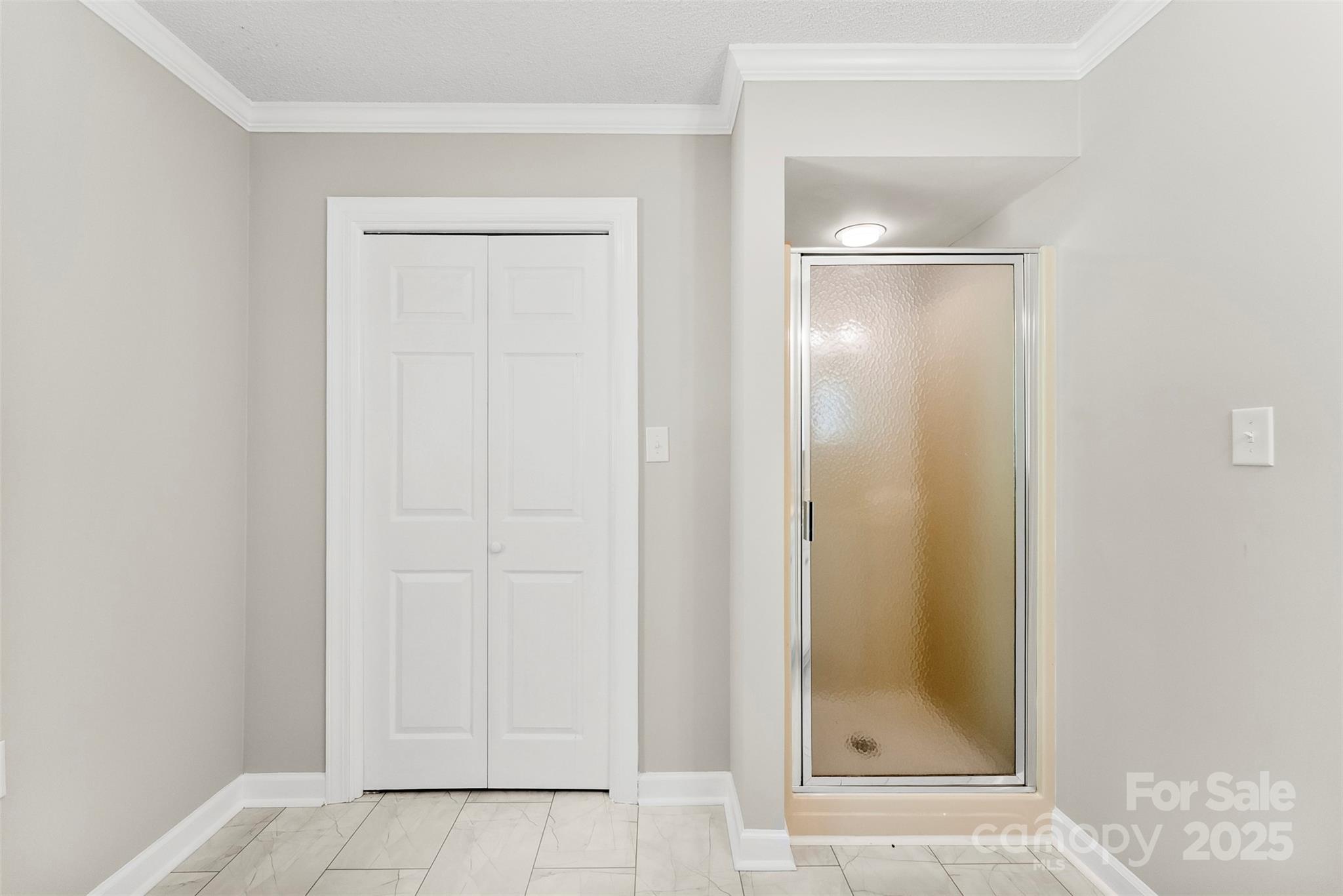 1505 North Cansler Street Kings Mountain, NC 28086 - Photo 15 of 46 a bathroom with a glass shower door