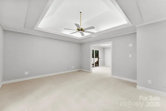 an empty room with a ceiling fan and a window