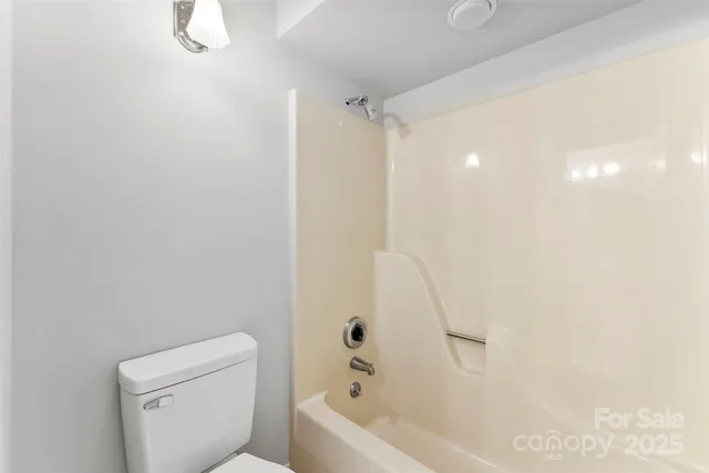 a bathroom with a bathtub a toilet and a shower