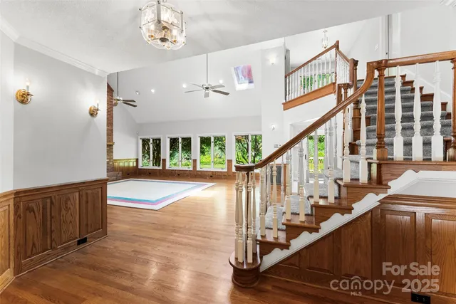 a view of staircase with large window and wooden floor