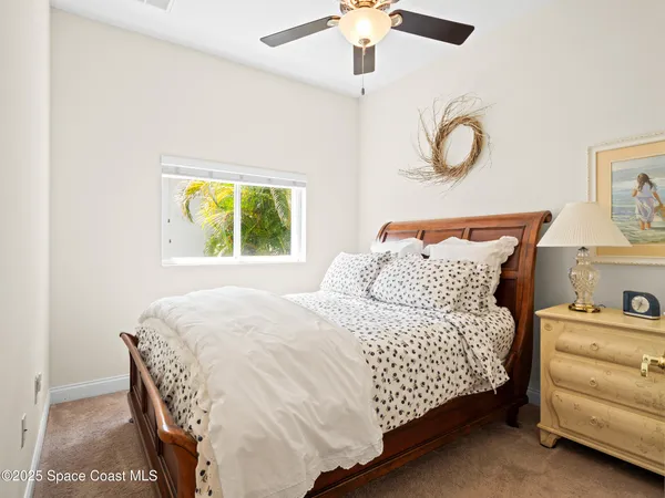a bathroom with a granite countertop sink a toilet and a large mirror