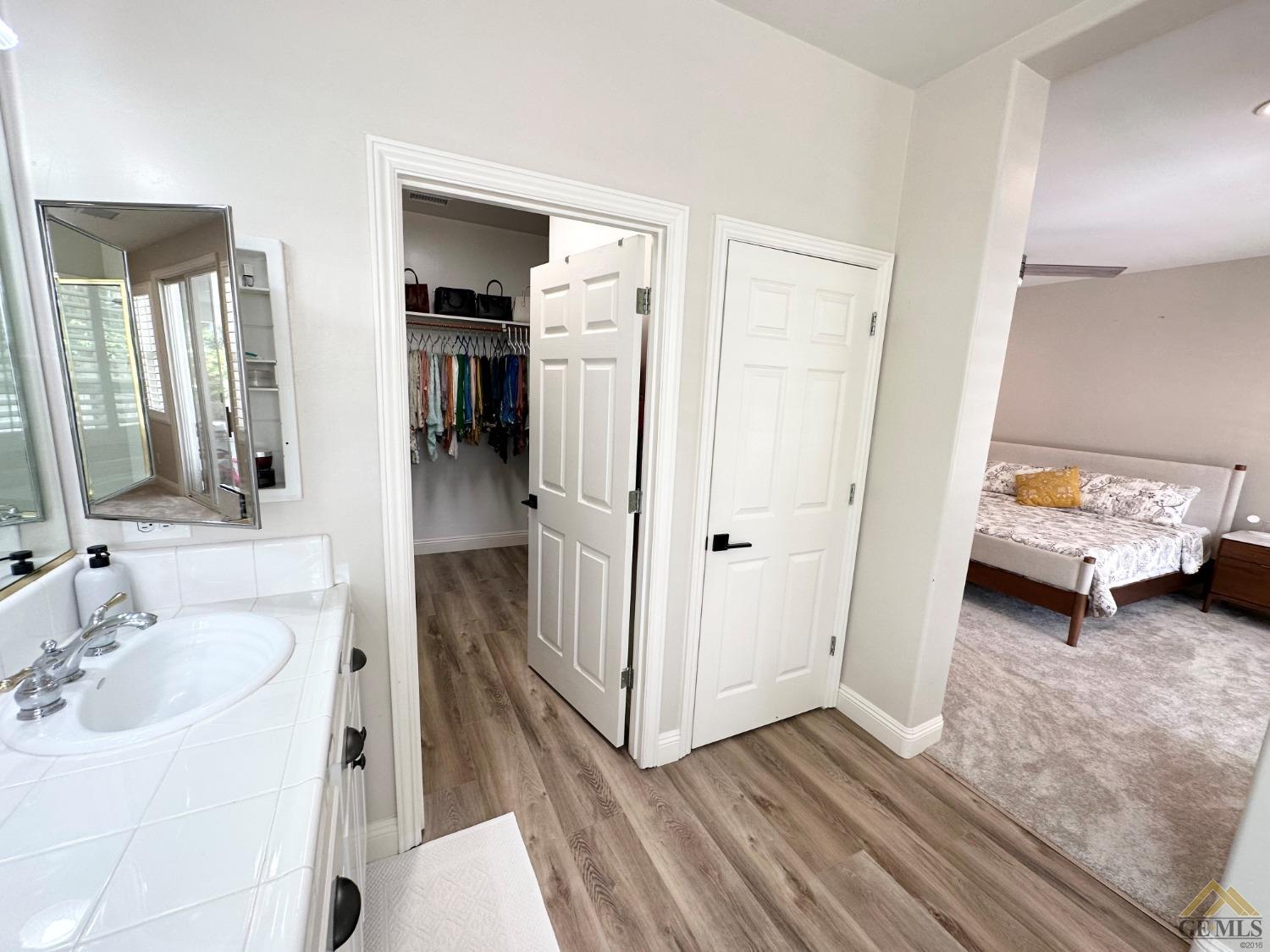 Undisclosed Address Bakersfield, CA 93311 - Photo 22 of 30 a en suite bathroom with a sink and a mirror