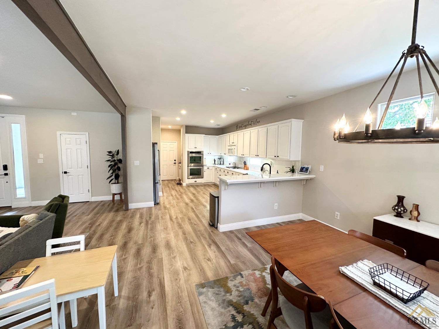 Undisclosed Address Bakersfield, CA 93311 - Photo 7 of 30 a living room with stainless steel appliances kitchen island granite countertop furniture and a view of kitchen