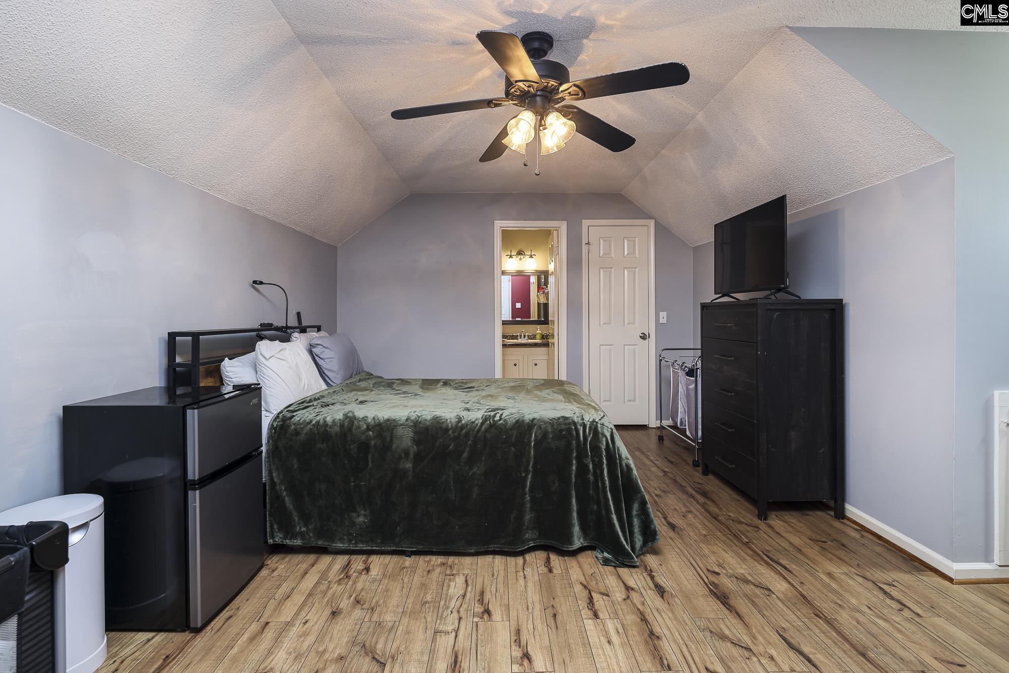 152 Thames Valley Court Irmo, SC 29063 - Photo 22 of 32 a bedroom with a bed and wooden floor