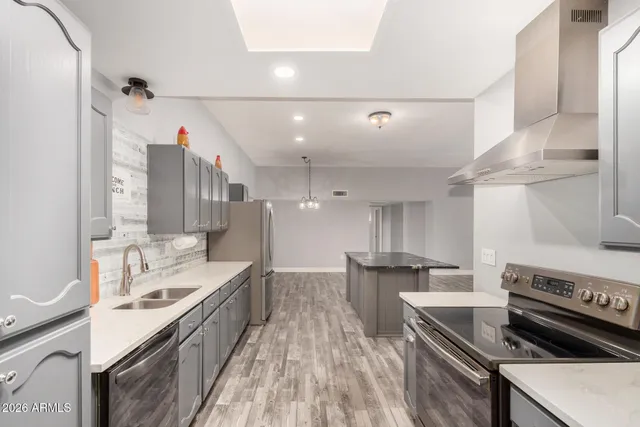 an empty room with a window and a ceiling fan