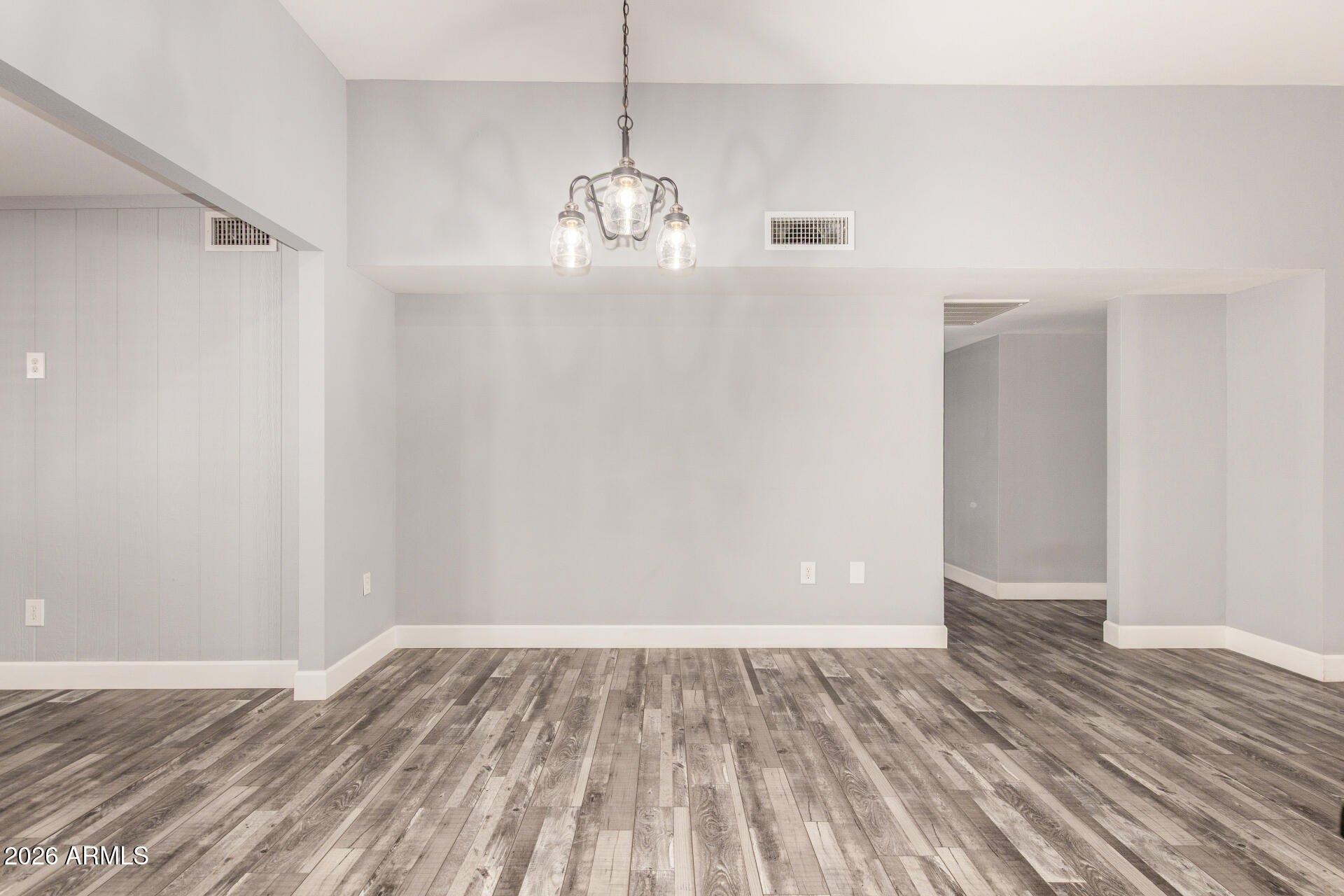 11118 West Mountain View Road Sun City, AZ 85351 - Photo 12 of 34 a view of empty room with wooden floor