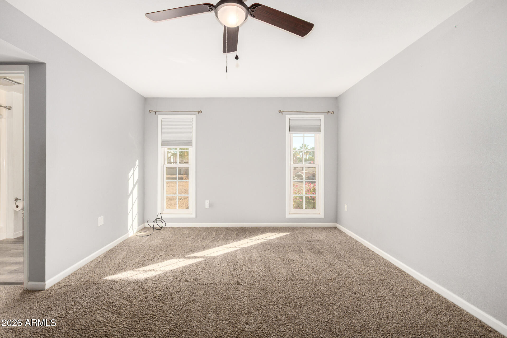 11118 West Mountain View Road Sun City, AZ 85351 - Photo 16 of 34 an empty room with a window and a ceiling fan