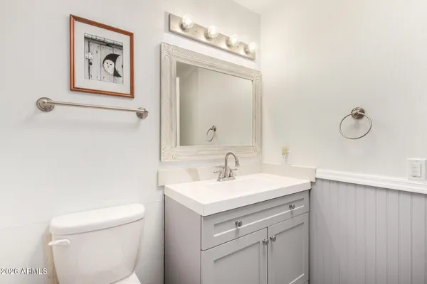 a bathroom with a toilet sink and mirror