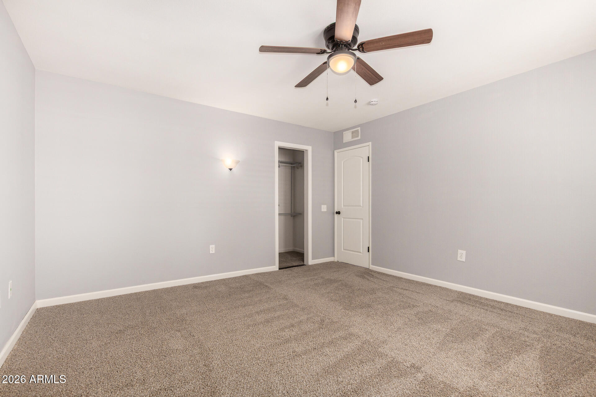 11118 West Mountain View Road Sun City, AZ 85351 - Photo 23 of 34 an empty room with a ceiling fan and a ceiling fan