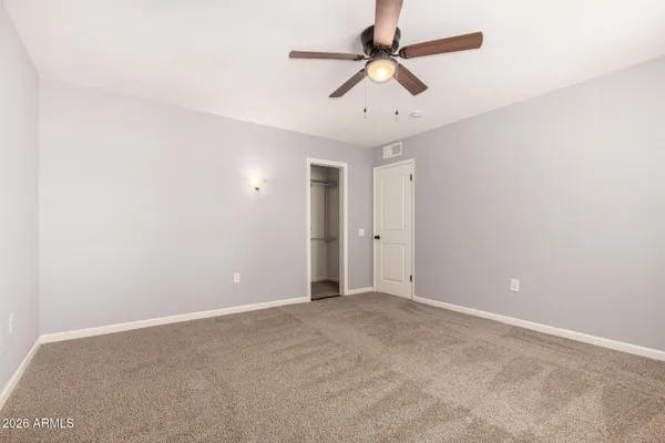 an empty room with a ceiling fan and a ceiling fan