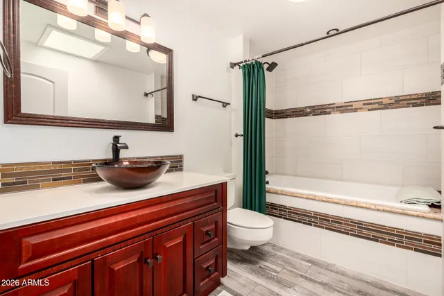 a view of a white house with a swimming pool and sitting area