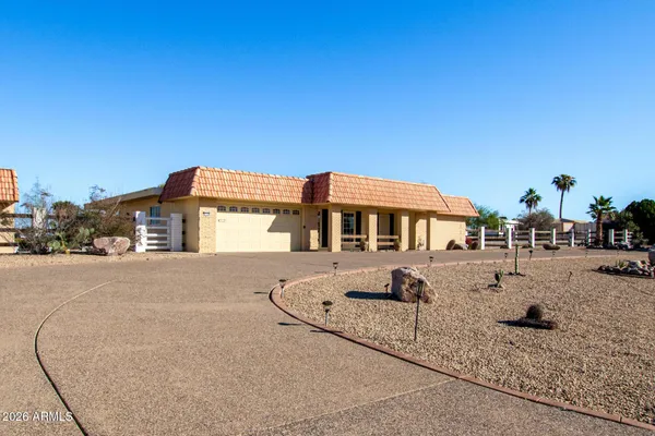 a view of a house with backyard and sitting area