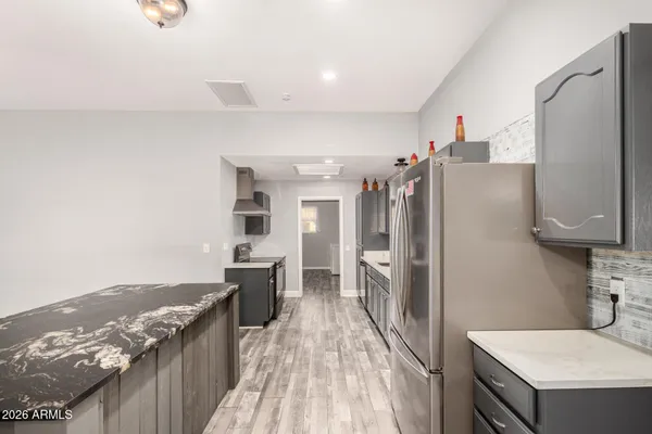 a kitchen with stainless steel appliances a refrigerator and a stove