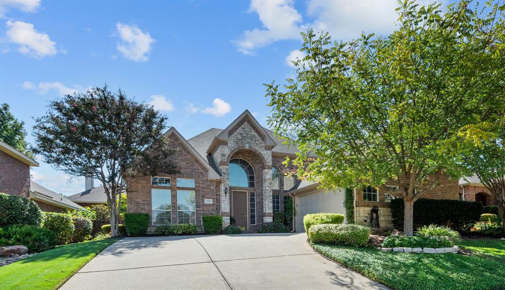 1107 Whispering Oaks Drive Keller, TX 76248 - Photo 1 of 1 View of front of home featuring a garage, concrete driveway, stone siding, a front lawn, and brick siding