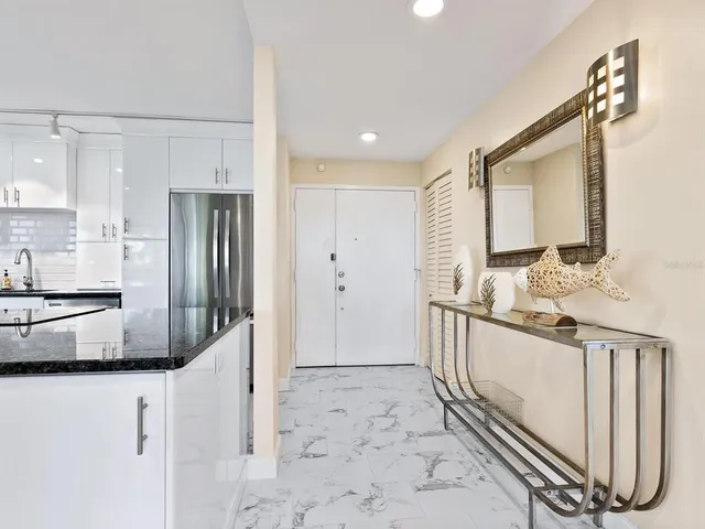a bathroom with a granite countertop sink mirror vanity and toilet