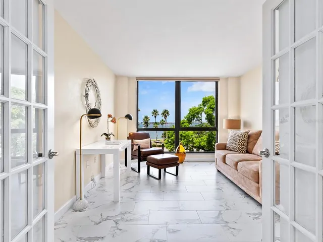 a bedroom with a bed and windows