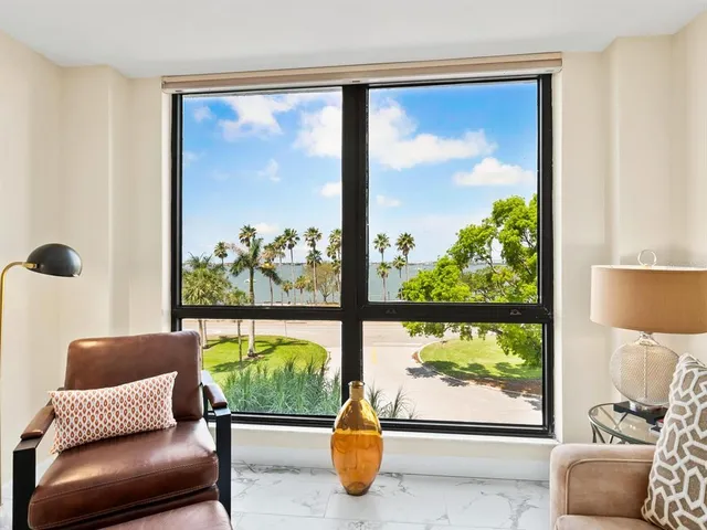 a view of a bedroom with furniture and window