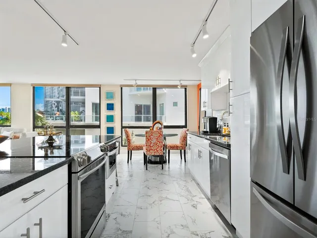a very nice looking living room with a large window and a table