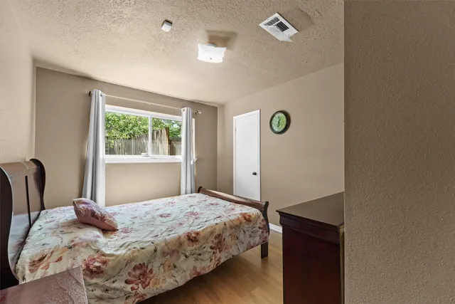 a bedroom with a bed and a window