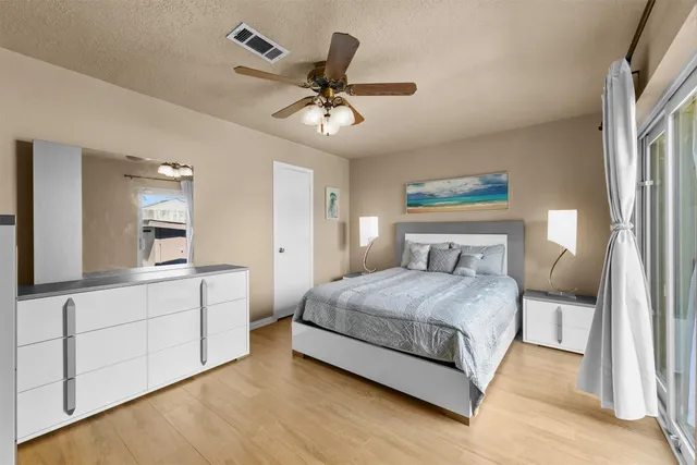 a bathroom with a granite countertop sink a toilet a mirror and shower