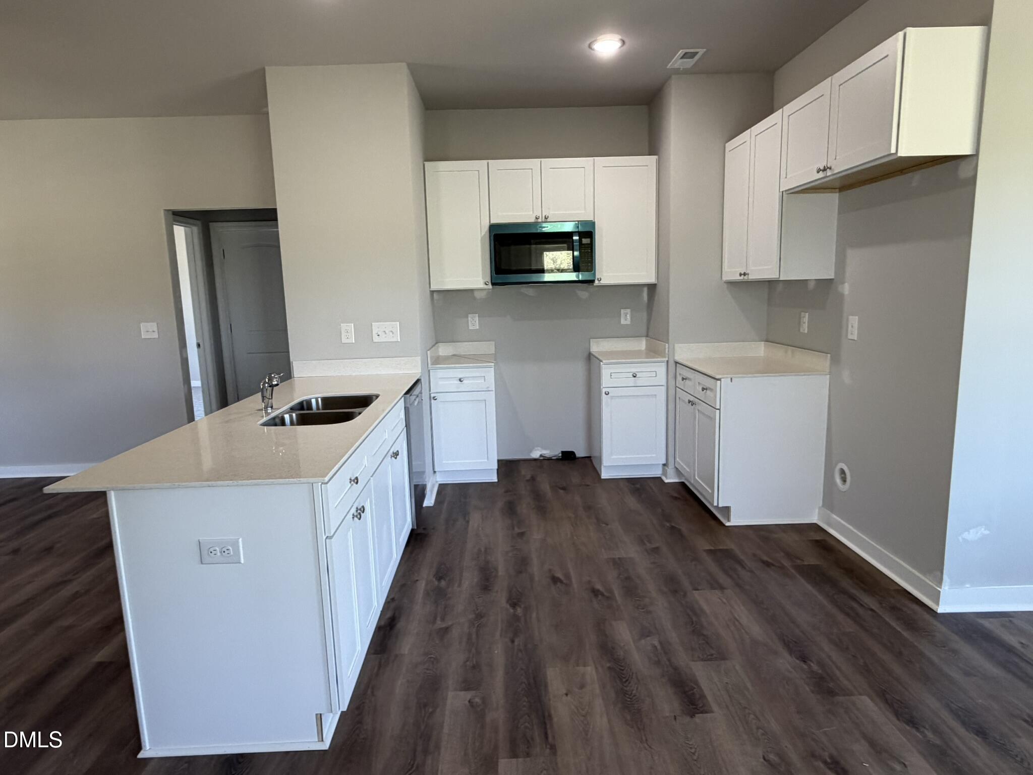 25 Jacobs Ridge Drive Four Oaks, NC 27524 - Photo 4 of 18 a kitchen with granite countertop white cabinets and wooden floor