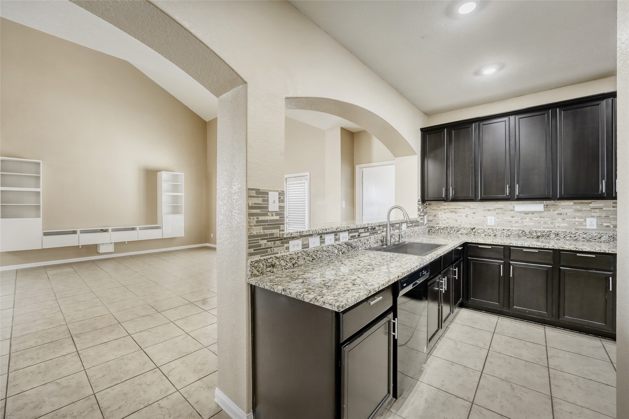 19621 Woodrow Wilson Street Manor, TX 78653 - Photo 34 of 34 a kitchen with a sink stove and cabinets