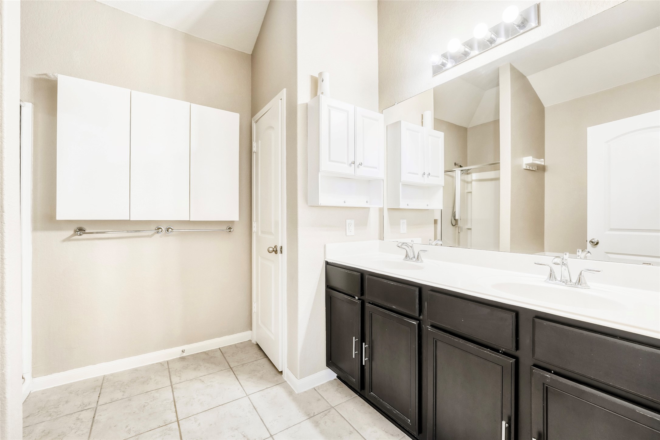 19621 Woodrow Wilson Street Manor, TX 78653 - Photo 15 of 34 a bathroom with a double vanity sink a mirror and a shower