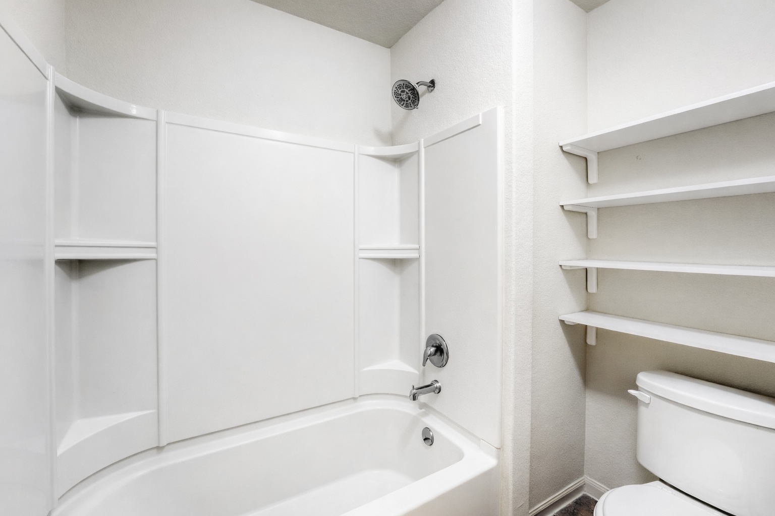 19621 Woodrow Wilson Street Manor, TX 78653 - Photo 20 of 34 a bathroom with a bathtub a toilet and a shower