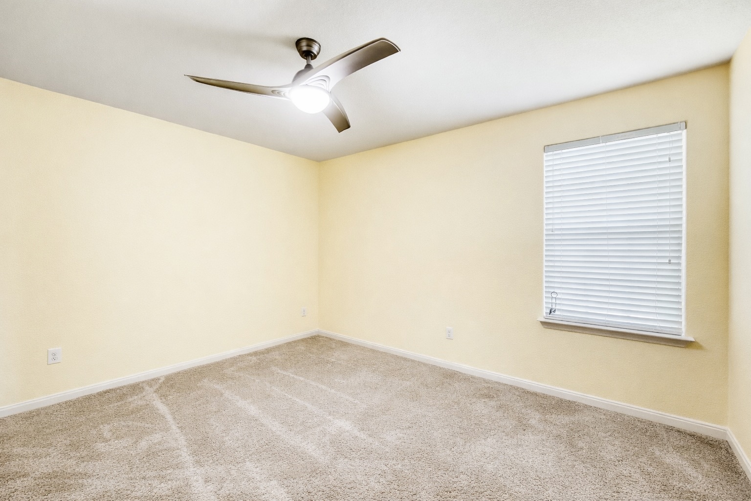 19621 Woodrow Wilson Street Manor, TX 78653 - Photo 23 of 34 a view of a big room with a ceiling fan and a window