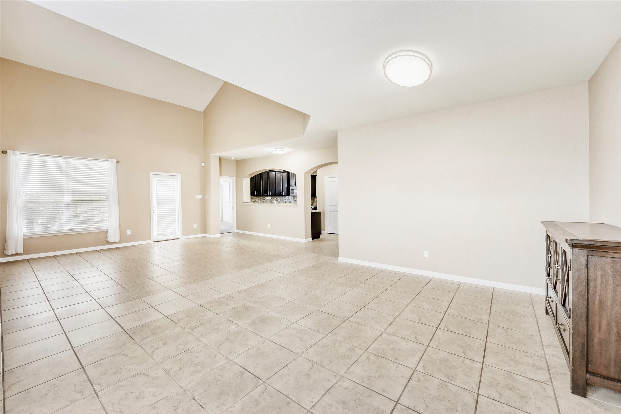 19621 Woodrow Wilson Street Manor, TX 78653 - Photo 5 of 34 a view of a livingroom with an empty space and a window