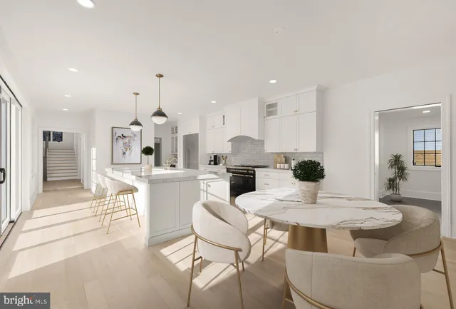 a kitchen with a dining table chairs and white cabinets