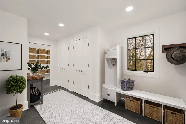 a living room with furniture a rug and a window
