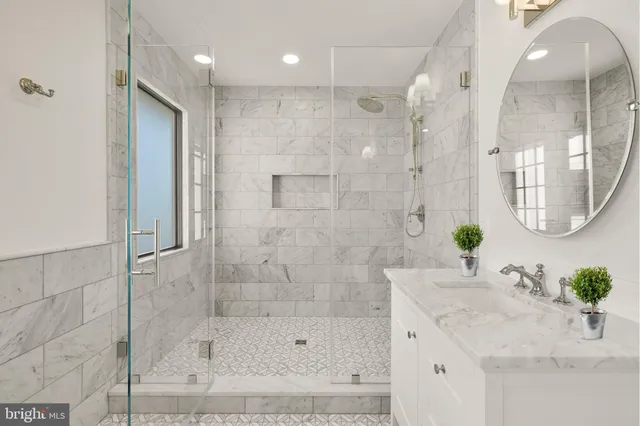 a bathroom with a bathtub shower sink and mirror