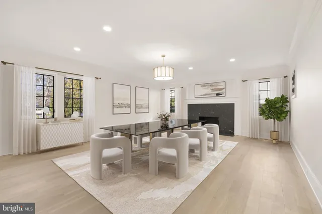 a living room with furniture a fireplace and a large window