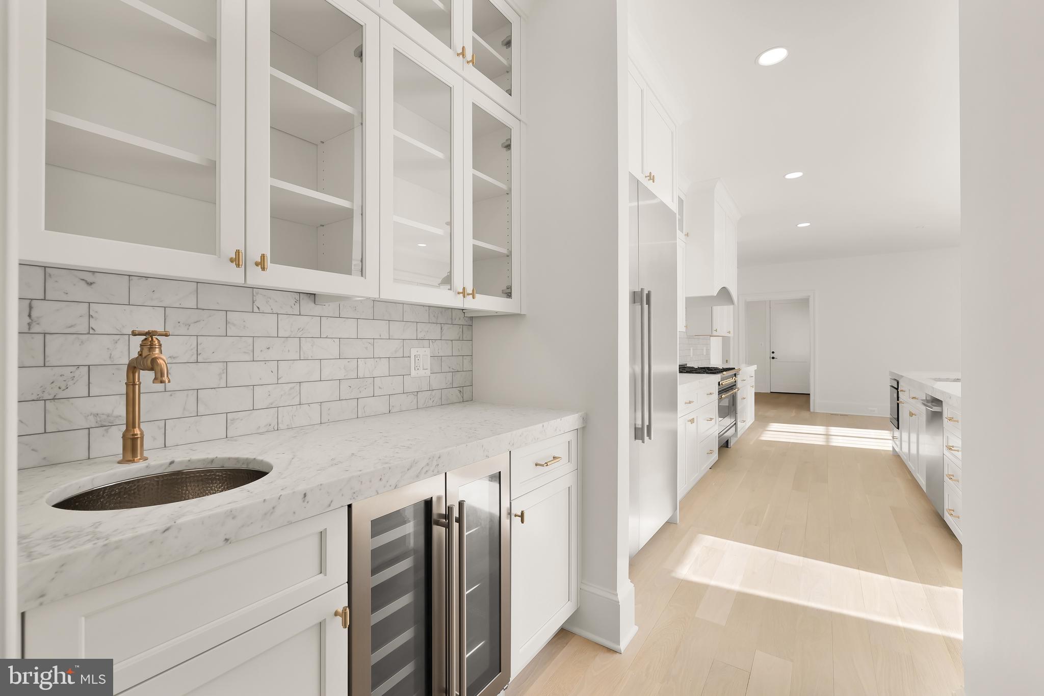 7611 Fairfax Road Bethesda, MD 20814 - Photo 10 of 44 a kitchen with a sink and a refrigerator