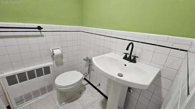 a bathroom with a toilet sink and shower
