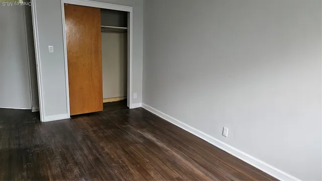 a view of hallway with wooden floor