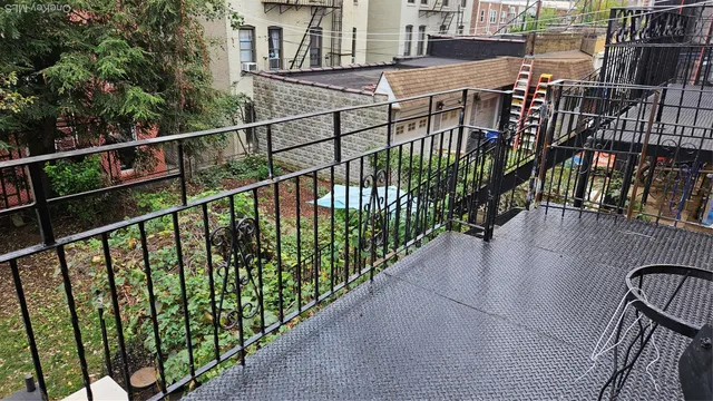 a view of balcony with wooden floor