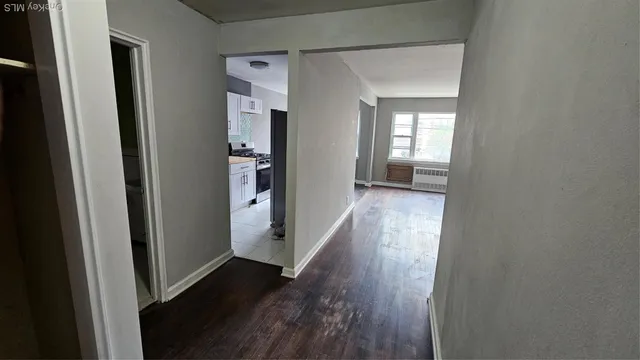a view of a hallway with wooden floor