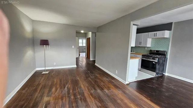 a view of a kitchen with wooden floor and electronic appliances